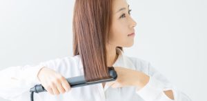female with curling iron