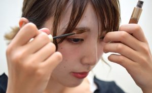 female applying eyebrow mascara